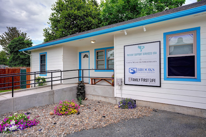 white office building with blue trim and a wheelchair accessible ramp with railing
